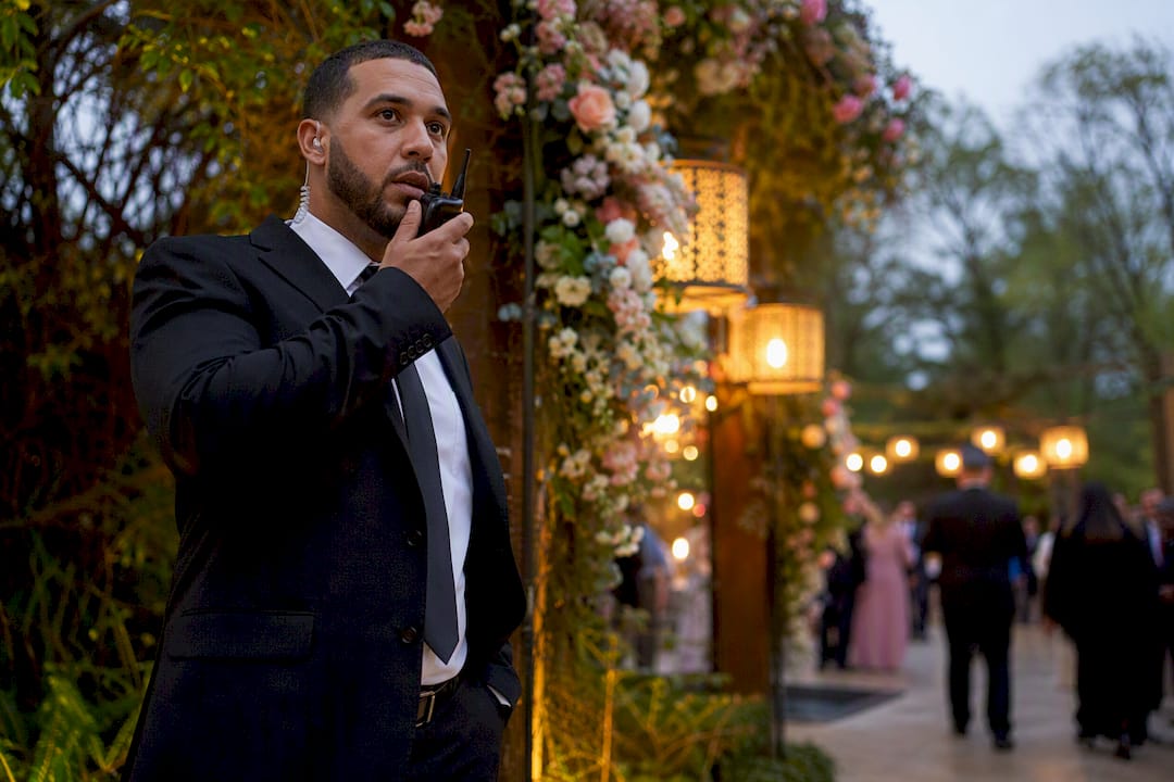 Security guard communicating via radio at wedding event