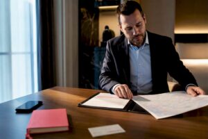 Security coordinator preparing executive travel brief